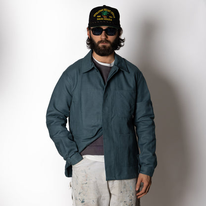 Men's green utility jacket with spread collar, long sleeves and front patch pockets