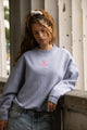 Women's gray crewneck sweatshirt with pink chest logo