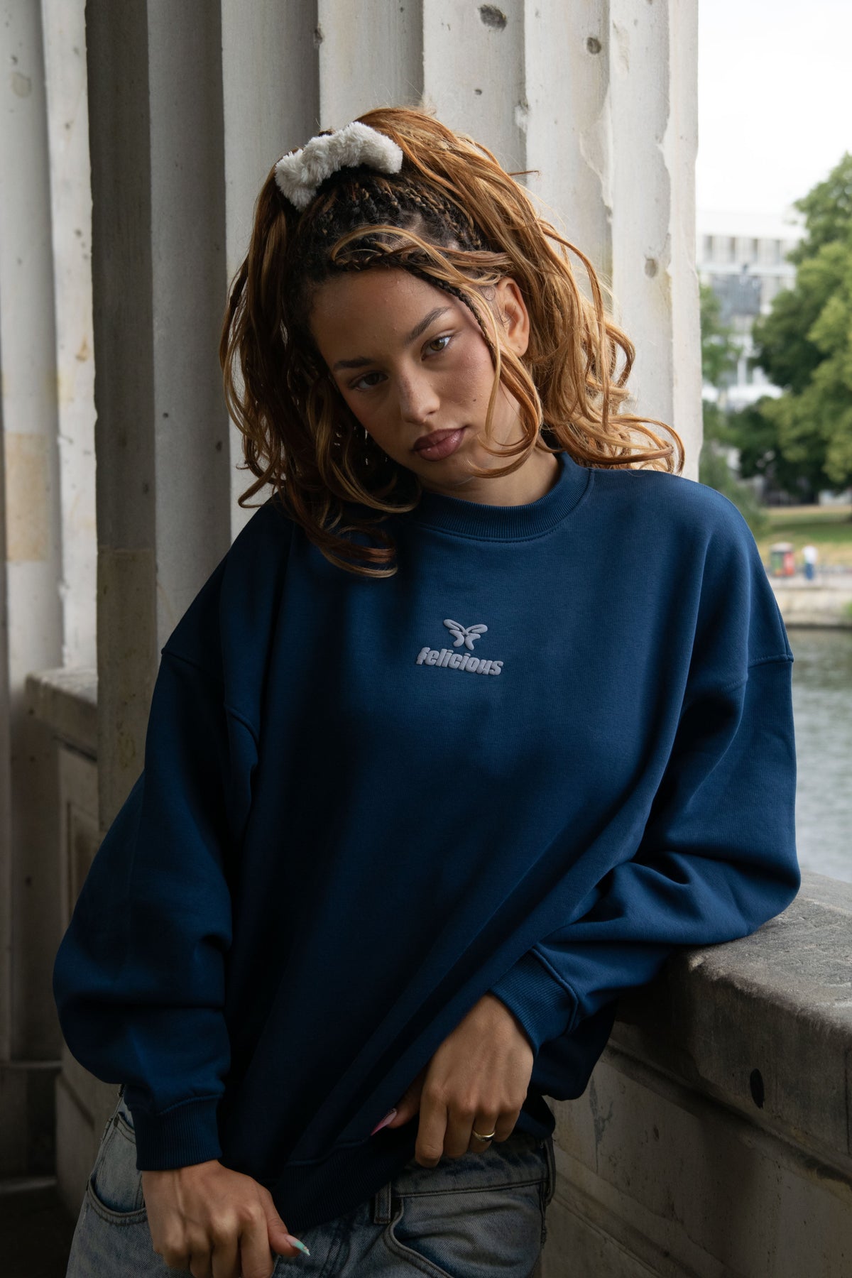 Women's blue crewneck sweatshirt with raised front logo