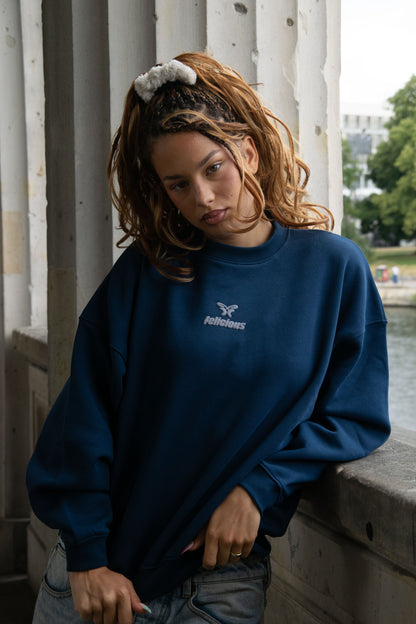 Women's blue crewneck sweatshirt with raised front logo