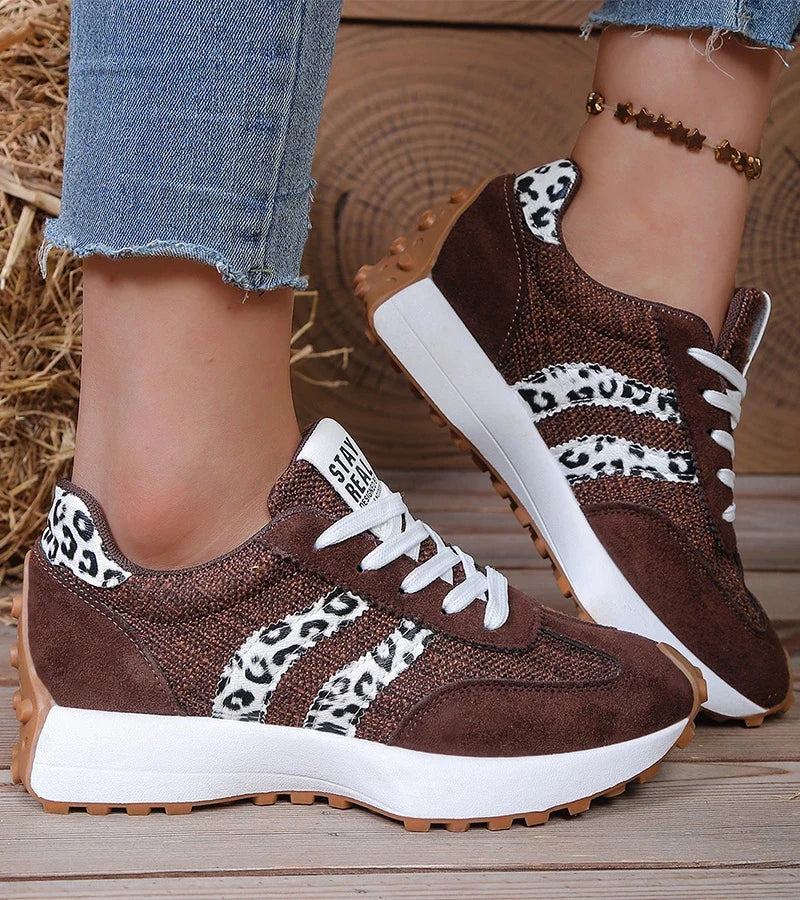 Low-top striped lace-up sneakers with contrasting panels and textured soles