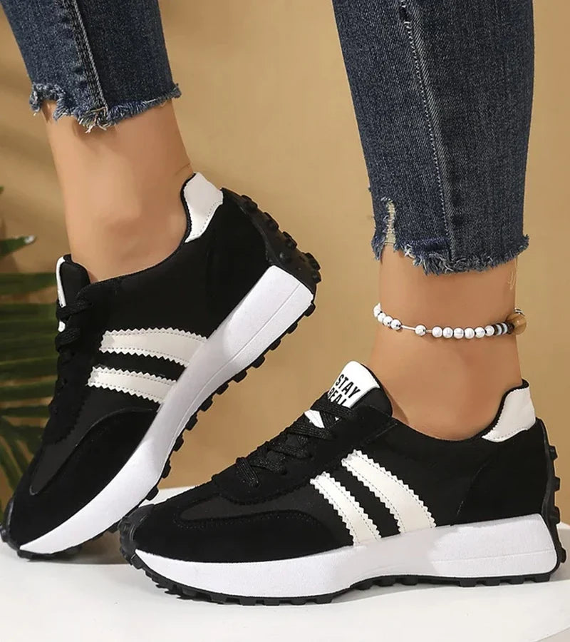 Low-top striped lace-up sneakers with contrasting panels and textured soles