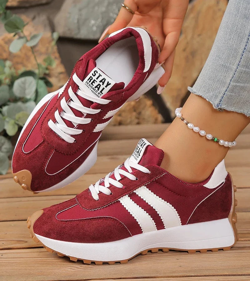 Low-top striped lace-up sneakers with contrasting panels and textured soles
