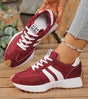 Low-top striped lace-up sneakers with contrasting panels and textured soles