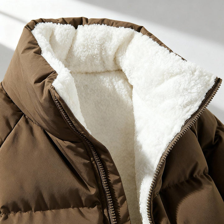 Women's hooded quilted puffer jacket with contrasting fleece-like lining and zip front