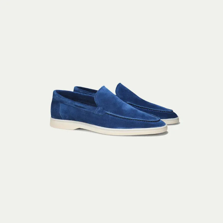 Men's blue slip-on loafers with textured finish and off-white flat soles