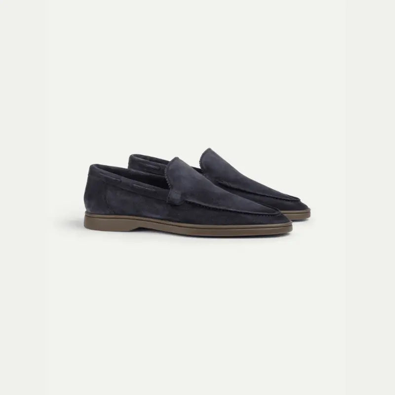 Navy men's penny loafers with moccasin stitching and brown sole