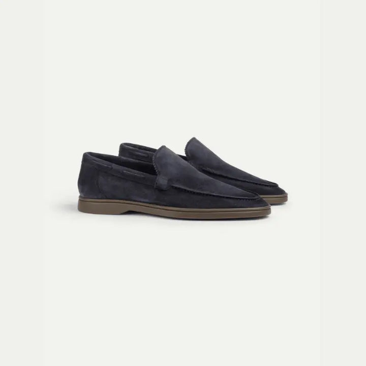 Navy men's penny loafers with moccasin stitching and brown sole