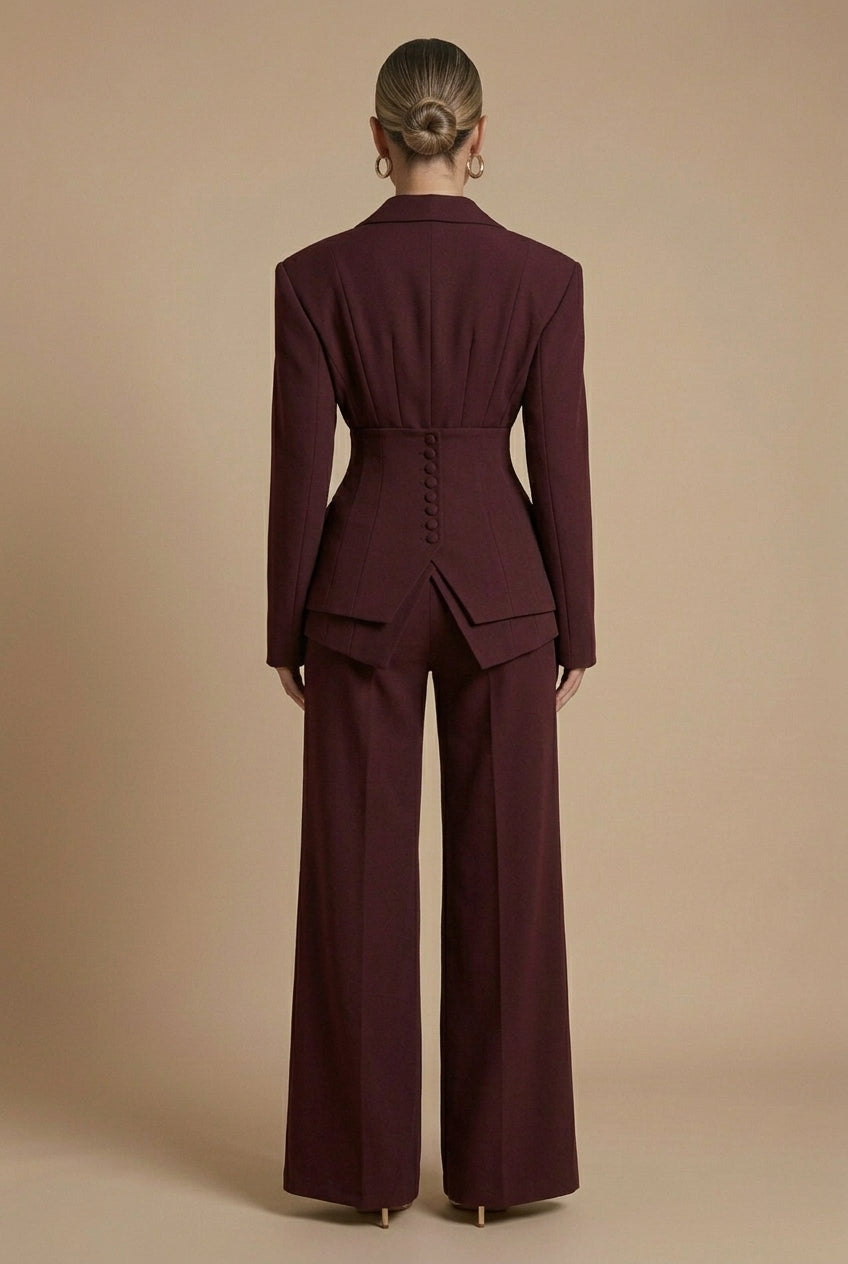 Women's tailored two-piece suit with peaked lapel jacket and wide-leg trousers