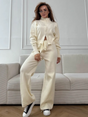Woman wearing a two-piece knit sweater and wide-leg trouser set