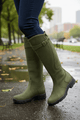 Women's knee-high boots with buckle strap and low heel