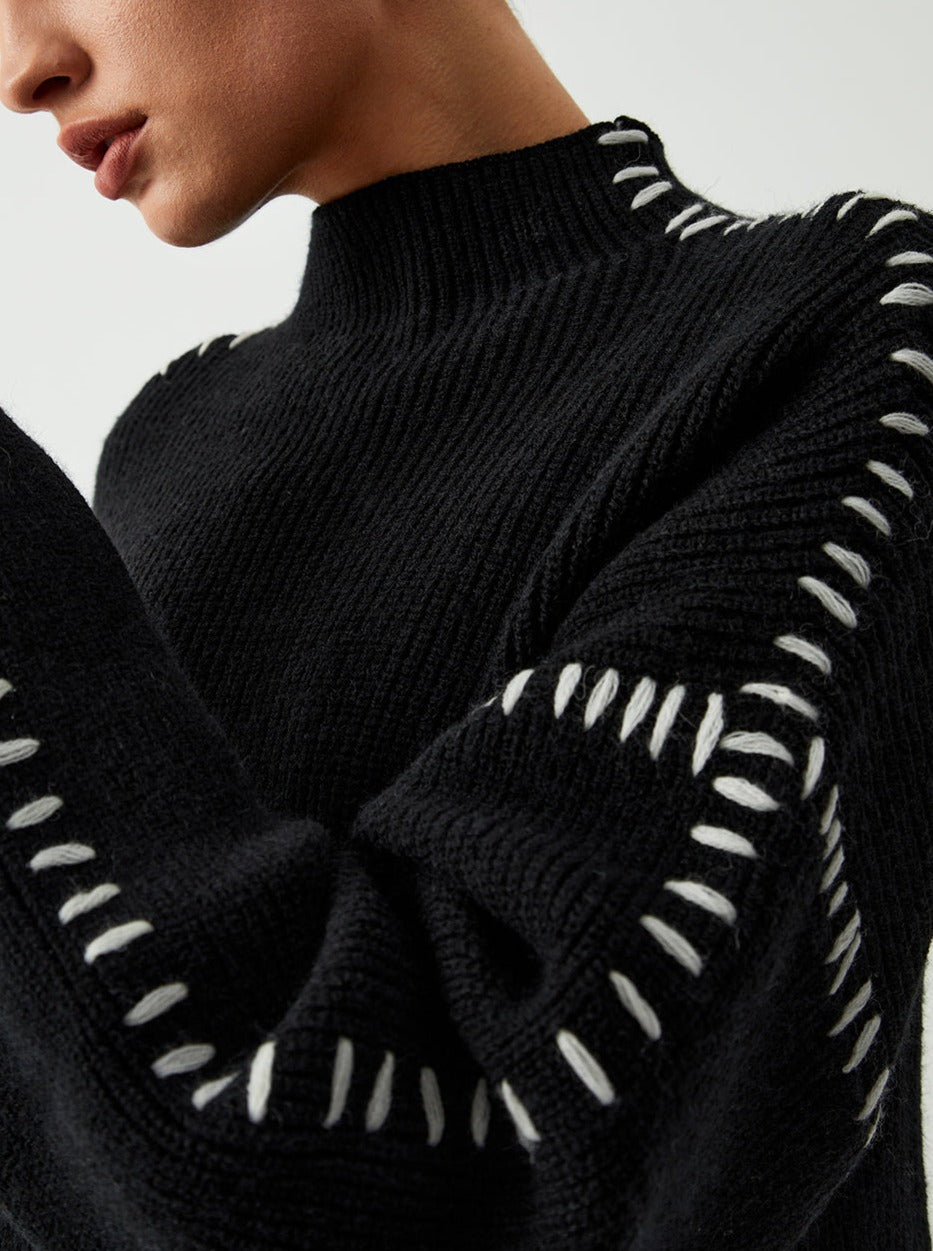 Women's crew neck knit sweater with contrasting stitch detailing on the sleeves