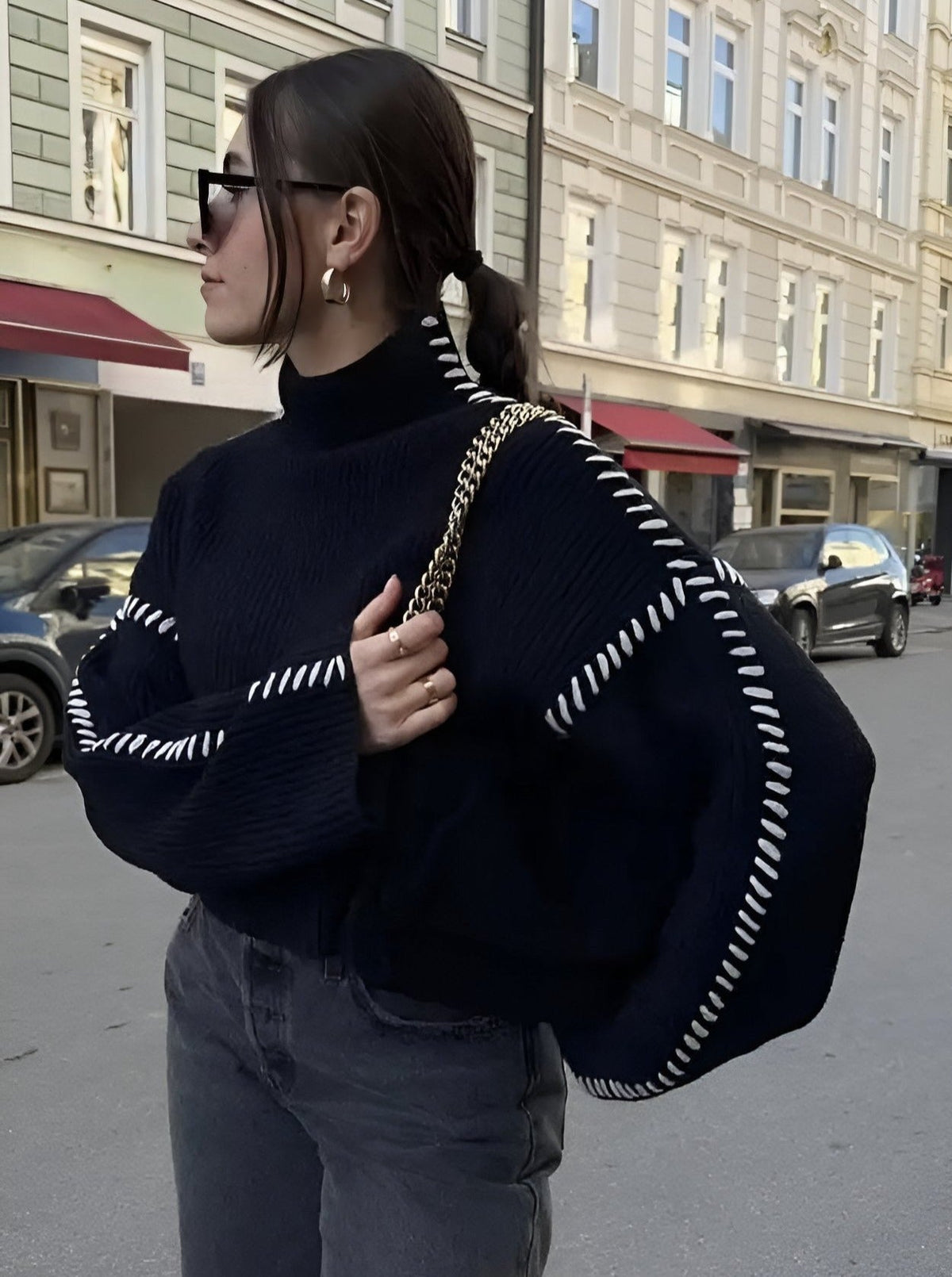 Women's crew neck knit sweater with contrasting stitch detailing on the sleeves