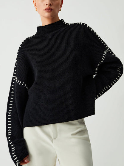 Women's crew neck knit sweater with contrasting stitch detailing on the sleeves