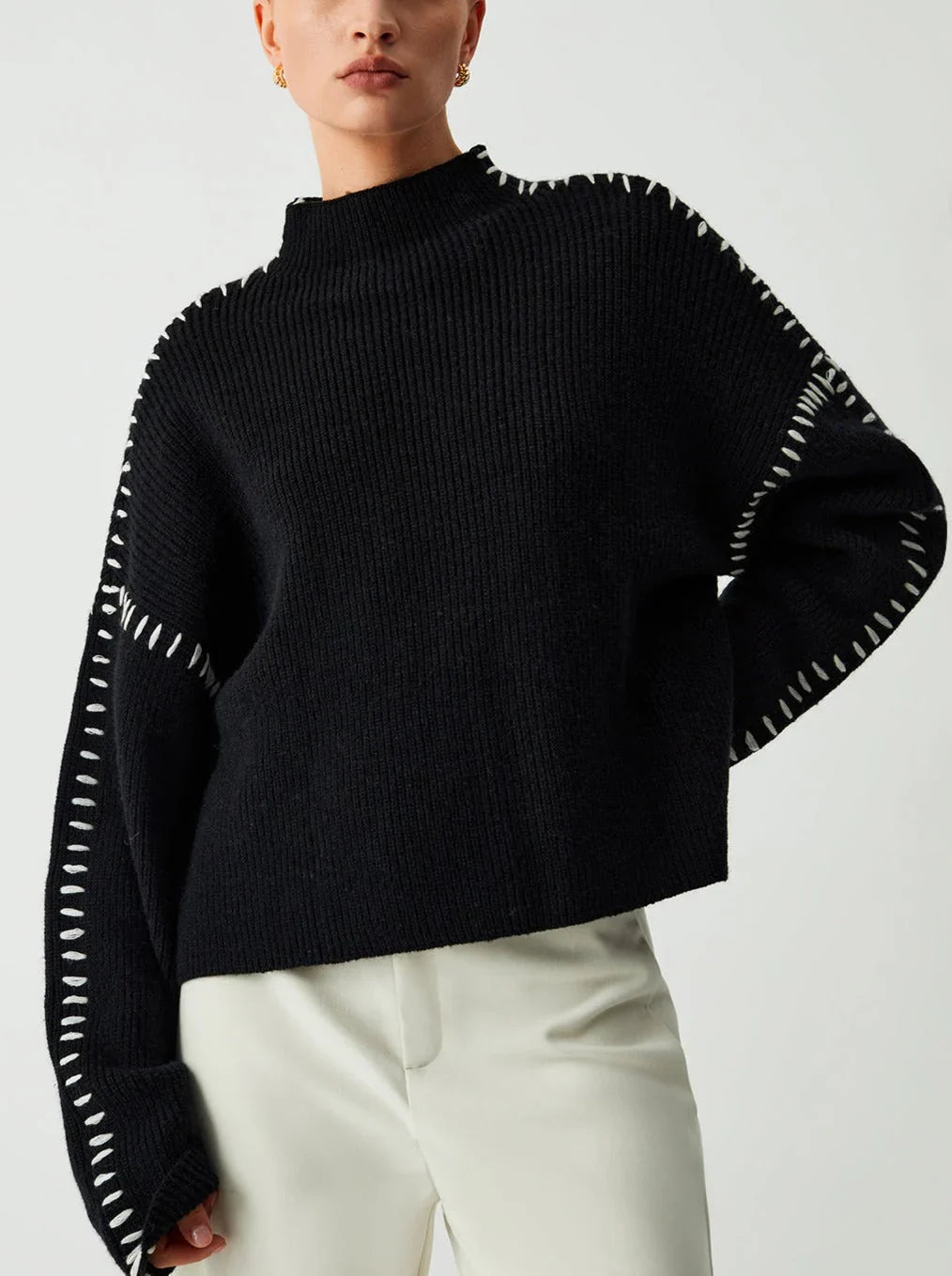 Women's crew neck knit sweater with contrast stitch detailing and long sleeves