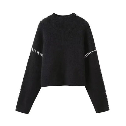 Women's crew neck knit sweater with contrasting stitch detailing on the sleeves