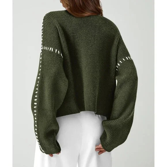 Women's crew neck knit sweater with contrasting stitch detailing on the sleeves