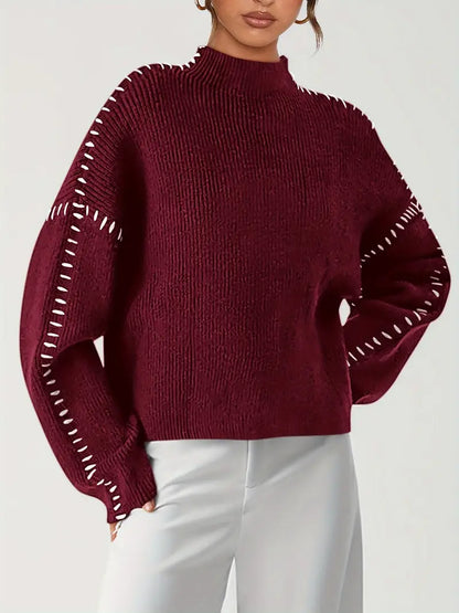 Women's crew neck knit sweater with contrasting stitch detailing on the sleeves