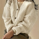 Women's beige chunky knit cardigan with cable panels and button front