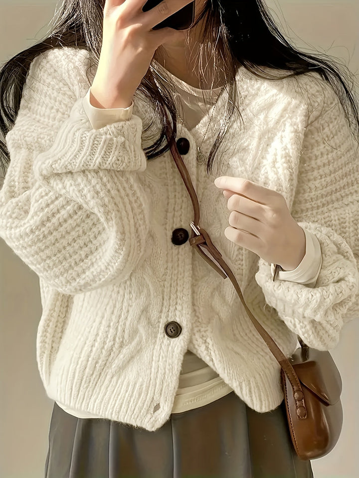 Women's beige chunky knit cardigan with cable panels and button front