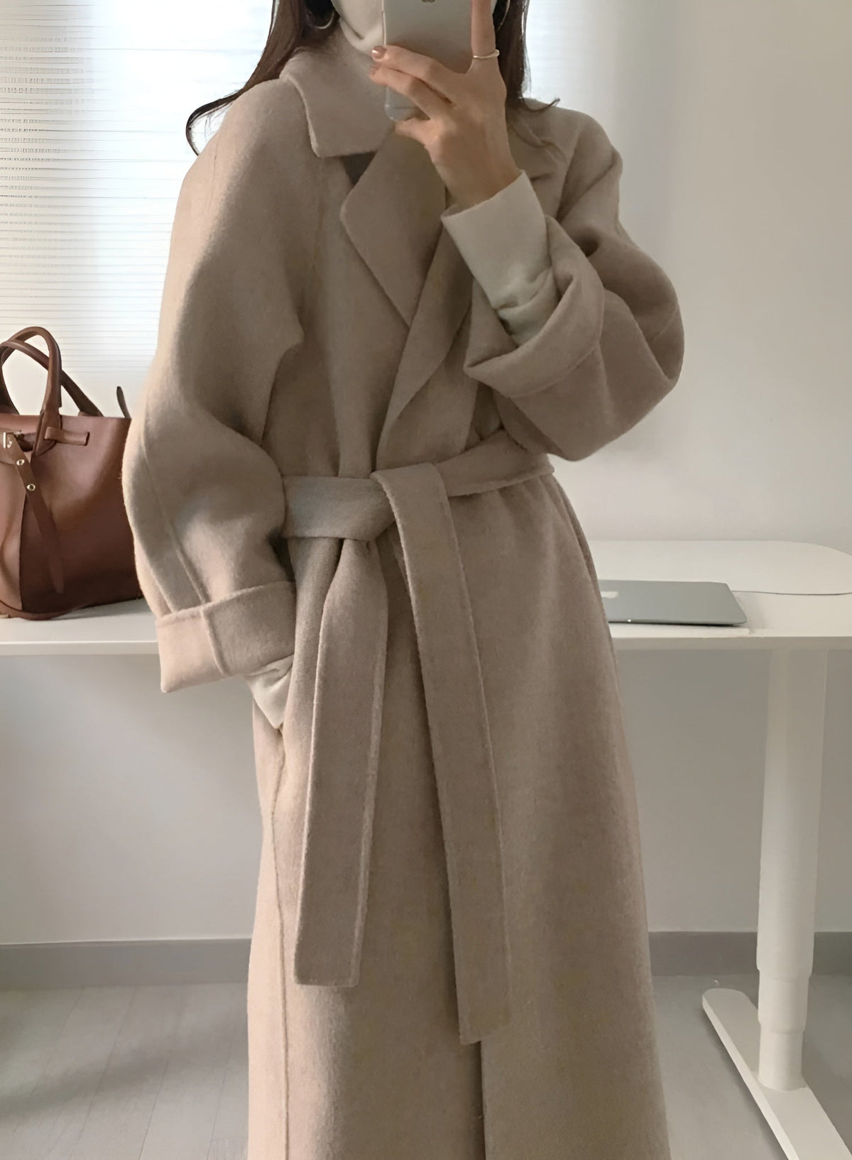 Women's long solid wrap coat with wide lapels and tie belt