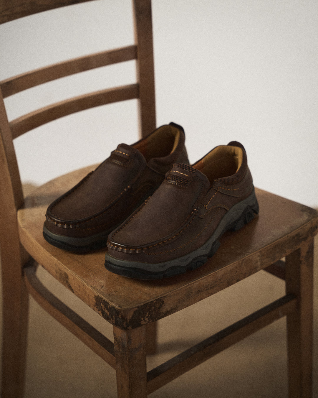 Men's casual moc toe loafers with stitched detailing and textured soles