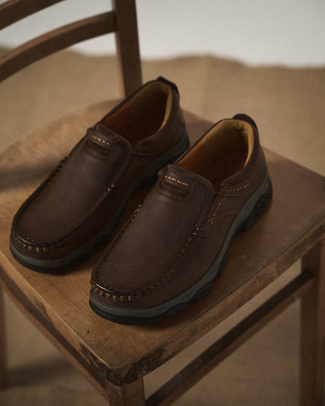 Men's casual moc toe loafers with stitched detailing and textured soles