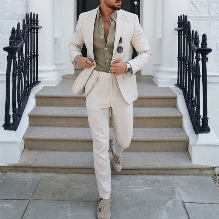 Man wearing beige two-piece slim fit suit with notched lapels and tapered trousers.
