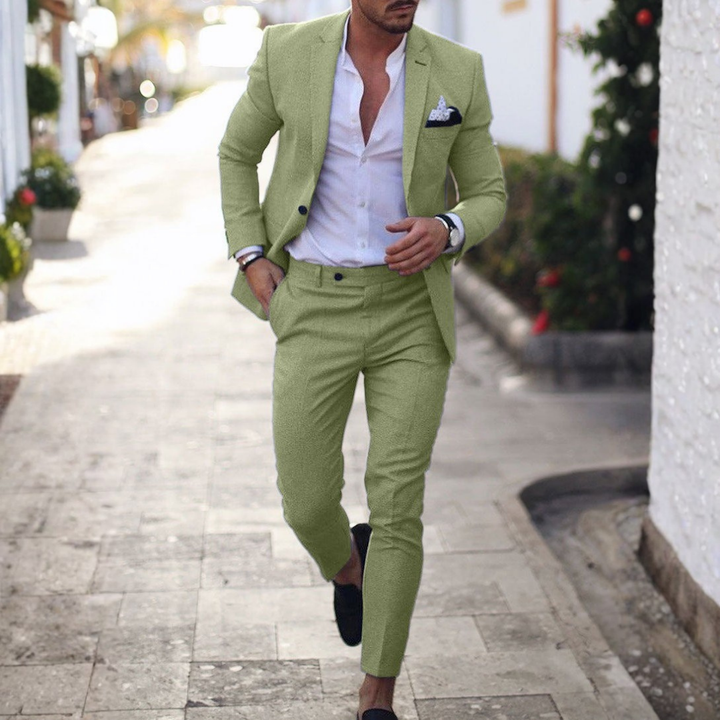 Man wearing beige two-piece slim fit suit with notched lapels and tapered trousers.