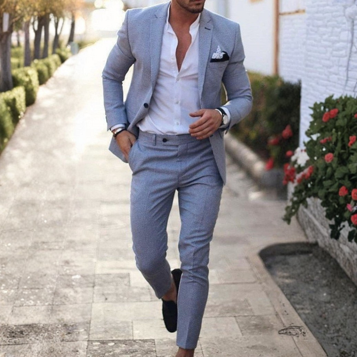 Man wearing beige two-piece slim fit suit with notched lapels and tapered trousers.