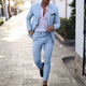 Man wearing beige two-piece slim fit suit with notched lapels and tapered trousers.