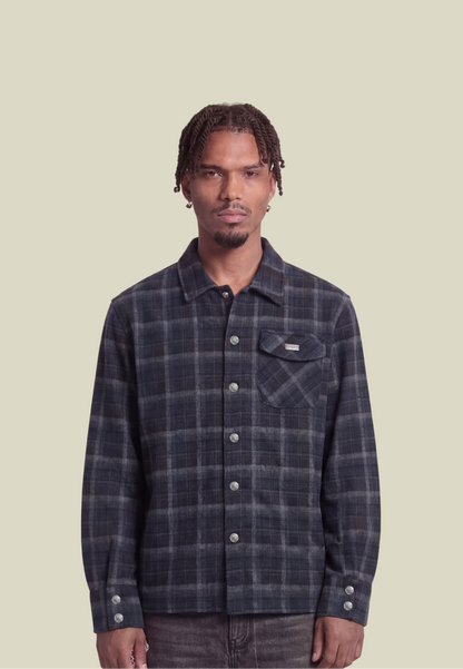 Men's navy plaid long-sleeve shirt with button front, chest pocket and decorative back motif