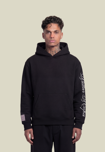 Black pullover hoodie with white sleeve graphic and front pouch pocket