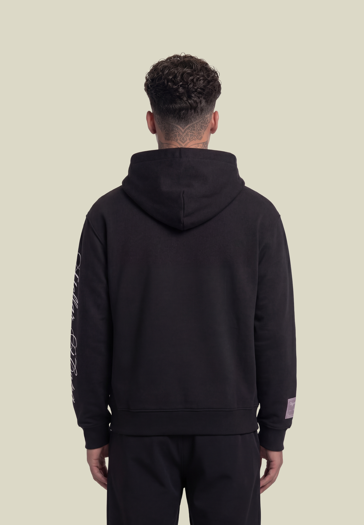 Black pullover hoodie with white sleeve graphic and front pouch pocket