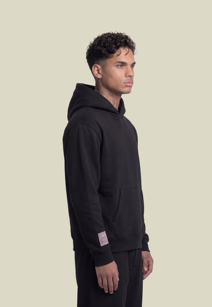 Black pullover hoodie with white sleeve graphic and front pouch pocket