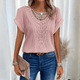 Woman wearing a relaxed waffle-knit top with an open crochet panel down the front and rolled cap sleeves