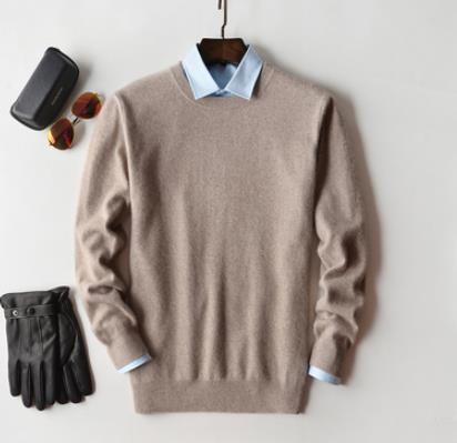 Men's plain knit crew neck sweater layered over a collared shirt