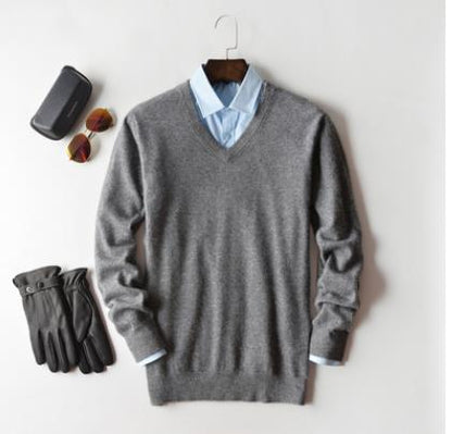 Men's plain knit crew neck sweater layered over a collared shirt