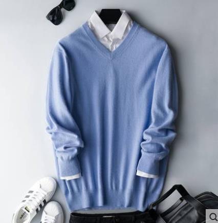 Men's plain knit crew neck sweater layered over a collared shirt