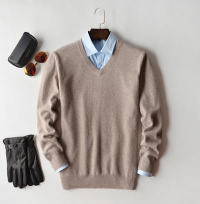 Men's plain knit crew neck sweater layered over a collared shirt