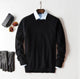 Men's plain knit crew neck sweater layered over a collared shirt