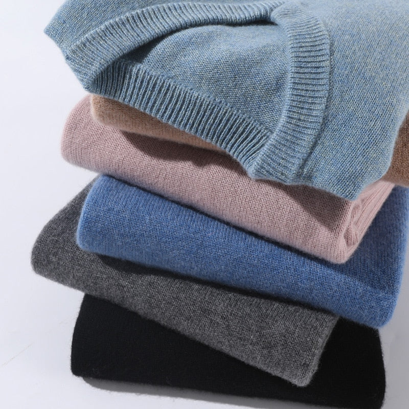 Men's plain knit crew neck sweater layered over a collared shirt