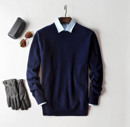 Men's plain knit crew neck sweater layered over a collared shirt