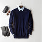 Men's plain knit crew neck sweater layered over a collared shirt
