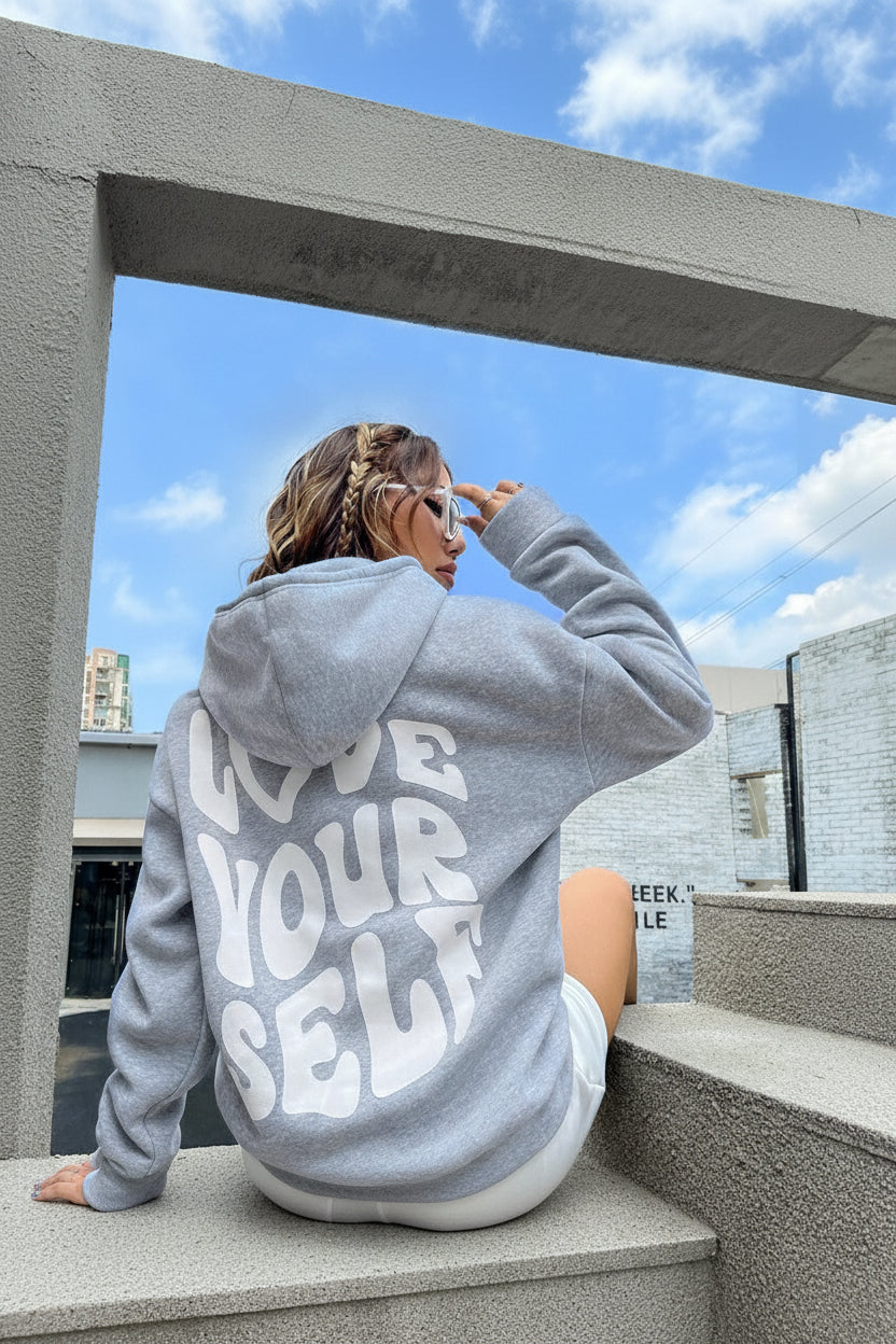 Women's hooded pullover with bold graphic lettering on the back