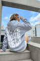 Women's hooded pullover with bold graphic lettering on the back
