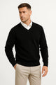 Men's plain V-neck sweater layered over a collared shirt
