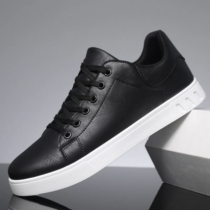 Men's low-top lace-up sneaker with stitched panels and white flat sole