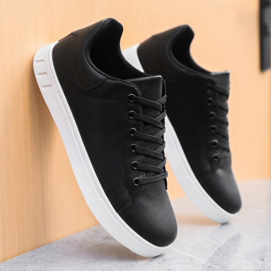 Men's low-top lace-up sneaker with stitched panels and white flat sole