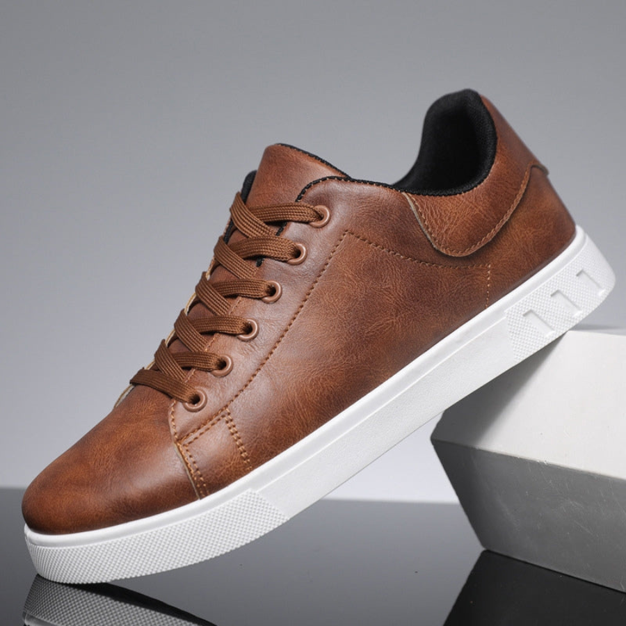 Men's low-top lace-up sneaker with stitched panels and white flat sole